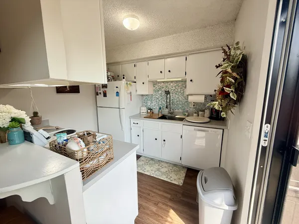 a kitchen with a sink appliances and cabinets