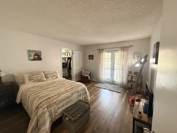 a bedroom with a bed a mirror and a window