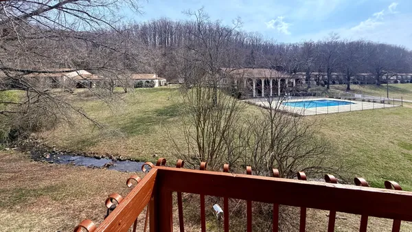 a view of swimming pool with a yard and sitting area