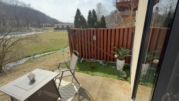 a view of a balcony with chair and table