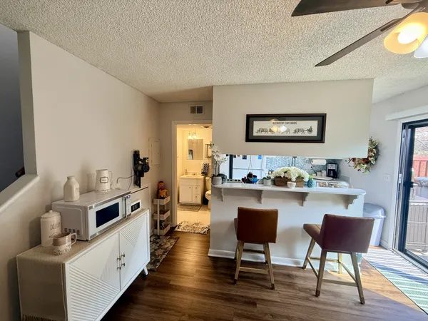 a kitchen with sink stove and chairs