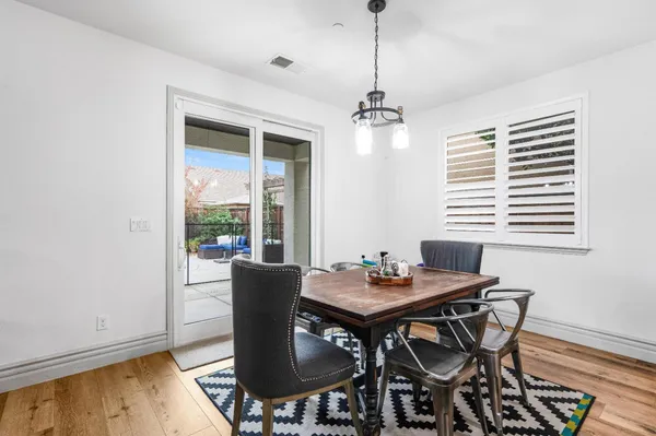 a kitchen with stainless steel appliances granite countertop a stove top oven a sink dishwasher a refrigerator and cabinets with wooden floor