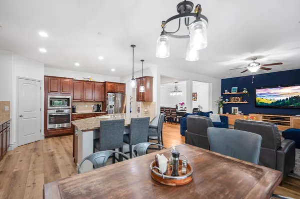 a kitchen with stainless steel appliances granite countertop a sink stove and cabinets