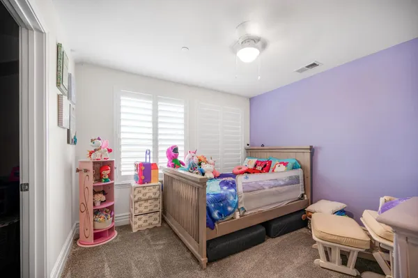 a bedroom with furniture and a baby crib