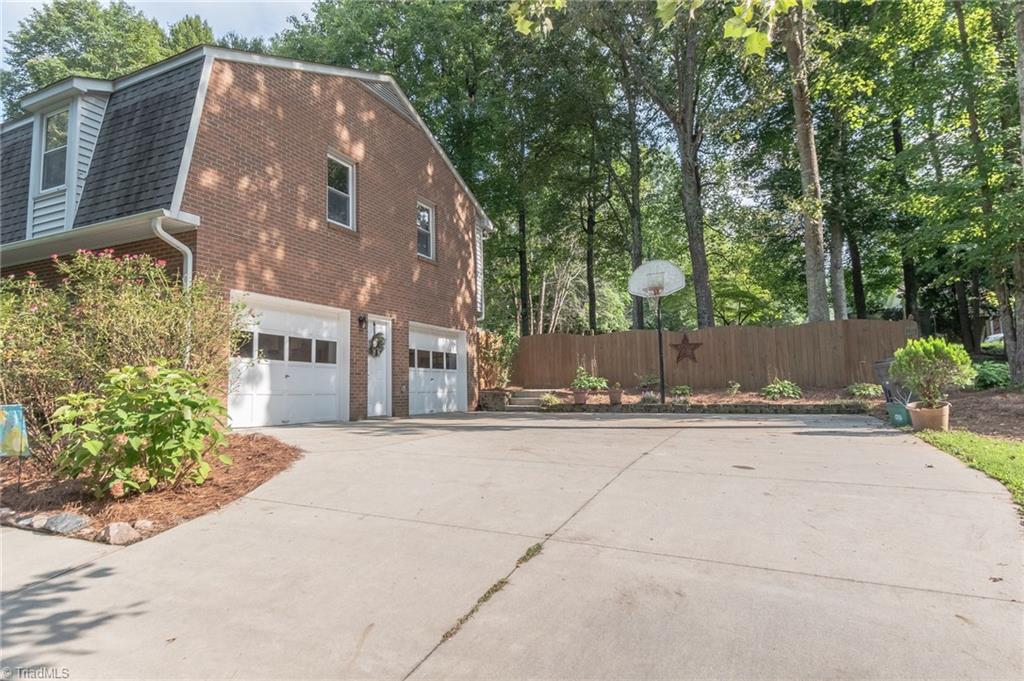 5808 Oakside Road Winston-Salem, NC 27104 - Photo 3 of 29 cement driveway leads to large 2-bay garage