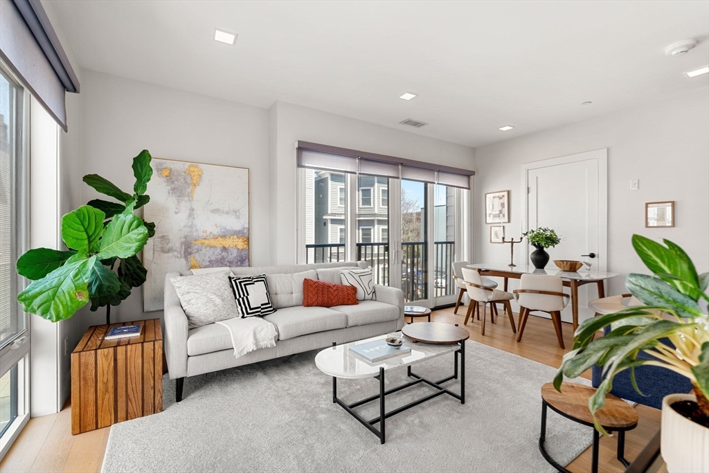 287 Maverick Street, Unit 201 Boston, MA 02128 - Photo 5 of 17 a living room with furniture and a potted plant