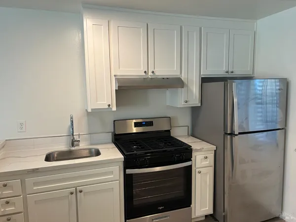 a kitchen with appliances and cabinets