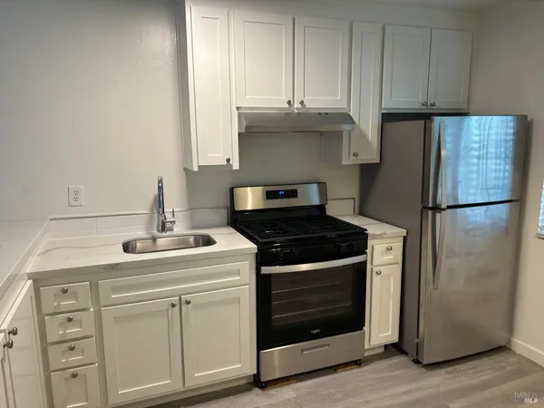 a kitchen with cabinets and appliances