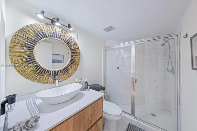 a bathroom with a sink a toilet and a shower