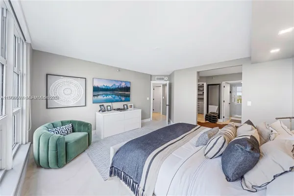 a bedroom with a bed and a couch