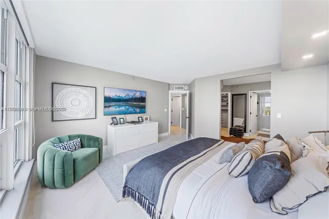 a bedroom with a bed and a couch