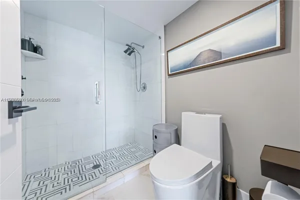 a bathroom with a toilet and a shower