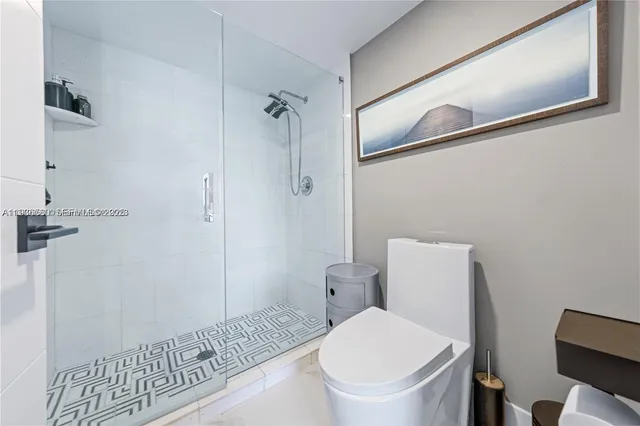 a bathroom with a toilet and a shower