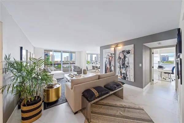 a living room with furniture and a potted plant