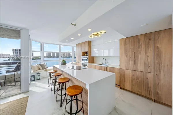 a large kitchen with a table and chairs
