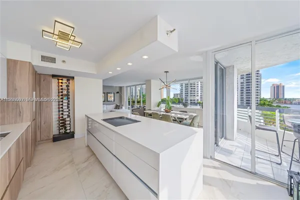 a large white kitchen with a large window