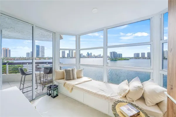 a bedroom with furniture and a large window