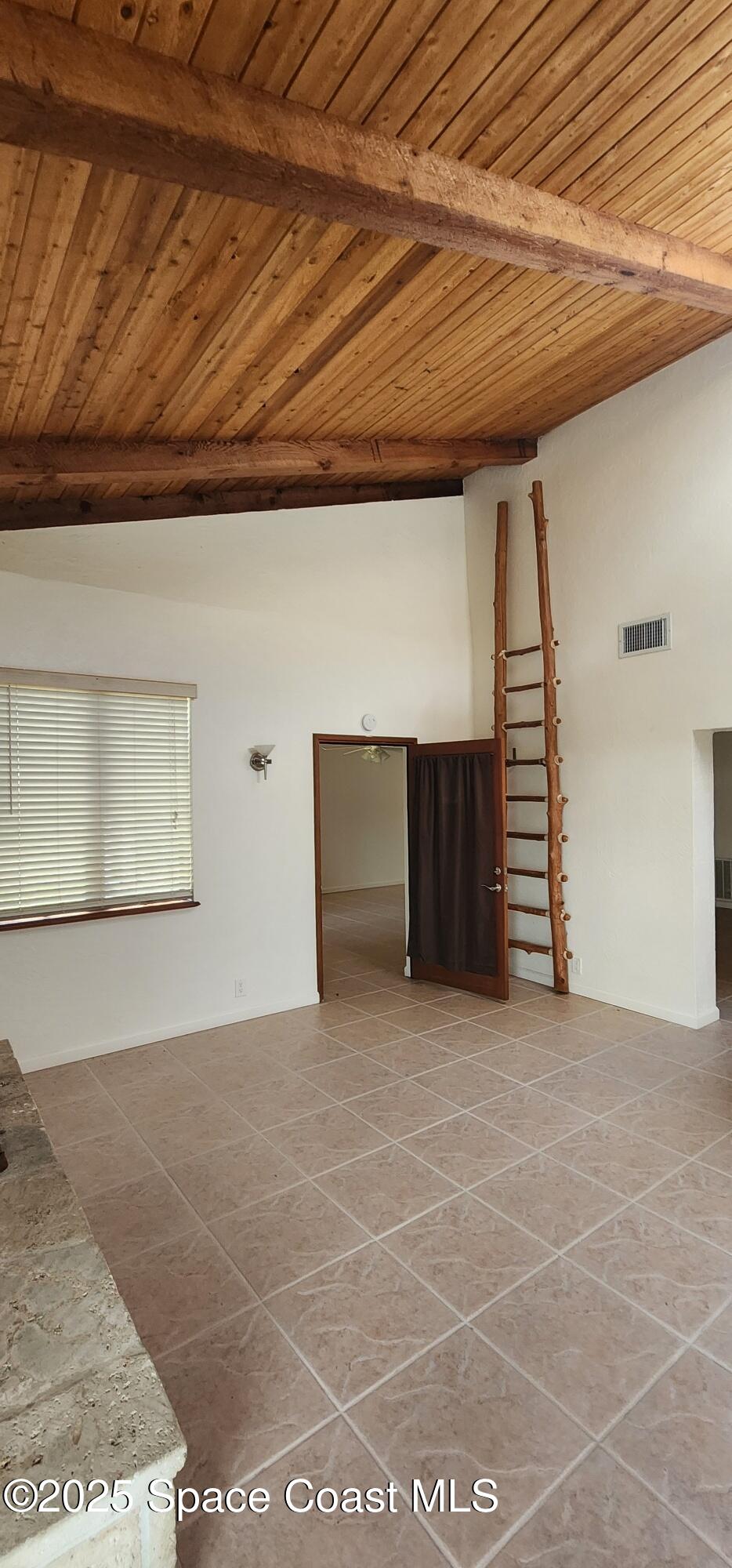 1041 Bali Road Cocoa Beach, FL 32931 - Photo 11 of 23 a view of an empty room with a fireplace
