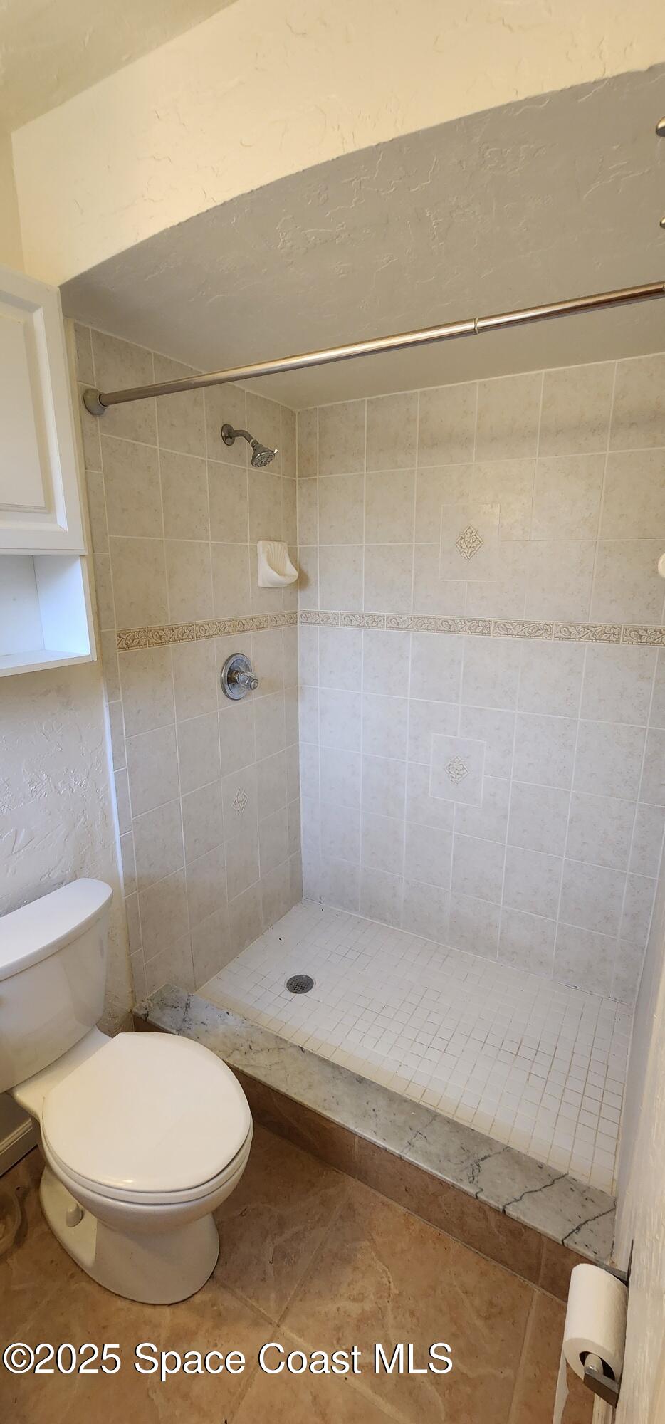 1041 Bali Road Cocoa Beach, FL 32931 - Photo 13 of 23 a bathroom with a toilet and a shower