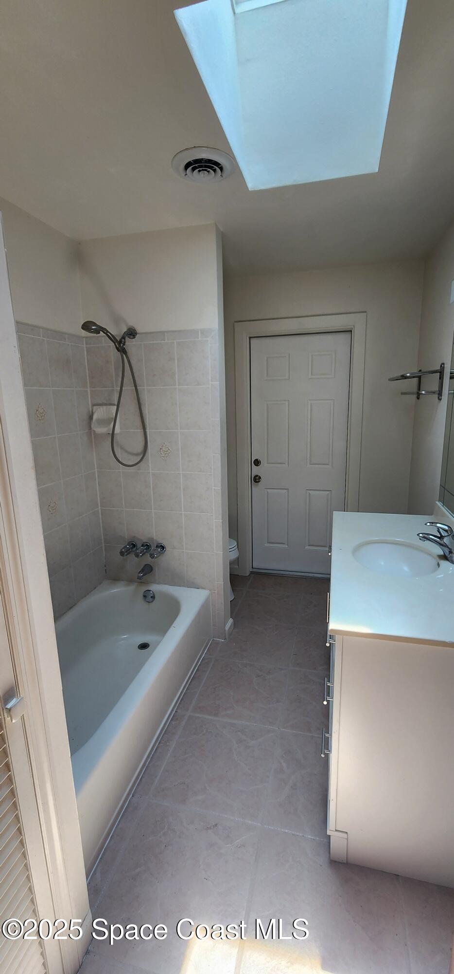1041 Bali Road Cocoa Beach, FL 32931 - Photo 14 of 23 a bathroom with a granite countertop sink a toilet and bathtub