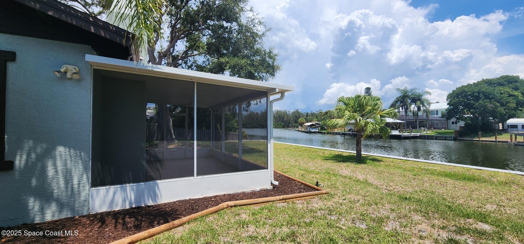 1041 Bali Road Cocoa Beach, FL 32931 - Photo 19 of 23 a house view with a garden space