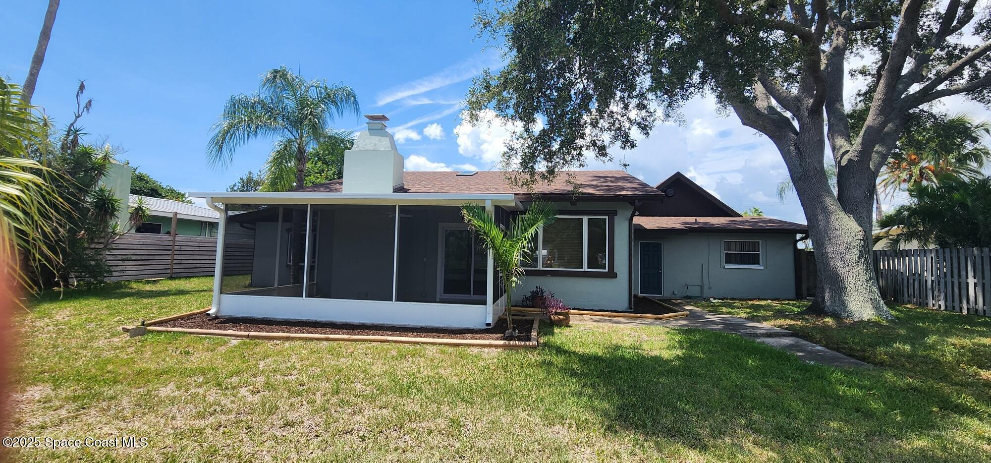 1041 Bali Road Cocoa Beach, FL 32931 - Photo 2 of 23 front view of a house with a yard
