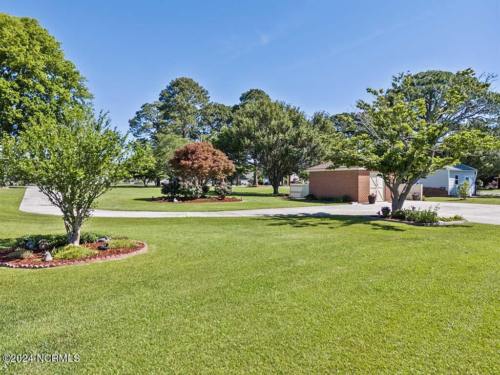 Set far from the road with a concrete driveway & parking pad ...