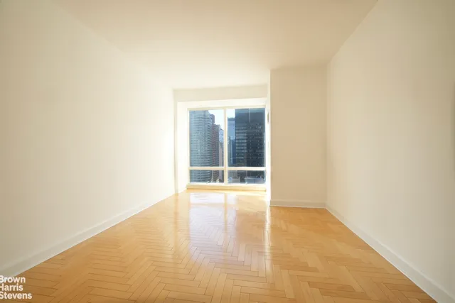 a view of an empty room with glass door