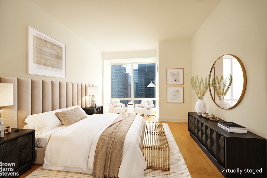 845 United Nations Plaza, Unit 33D Manhattan, NY 10017 - Photo 3 of 11 a bedroom with a bed a mirror and a window