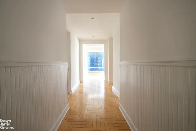 a bedroom with a bed a mirror and a window