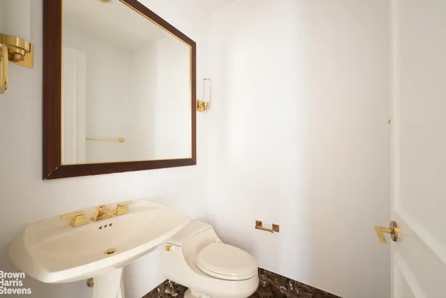 a bathroom with a double vanity sink mirror and toilet
