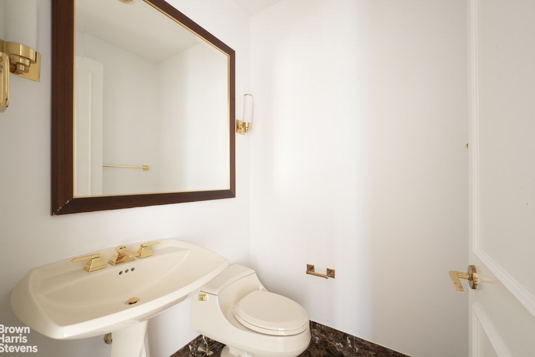 845 United Nations Plaza, Unit 33D Manhattan, NY 10017 - Photo 7 of 11 a white toilet sitting next to a bathroom sink