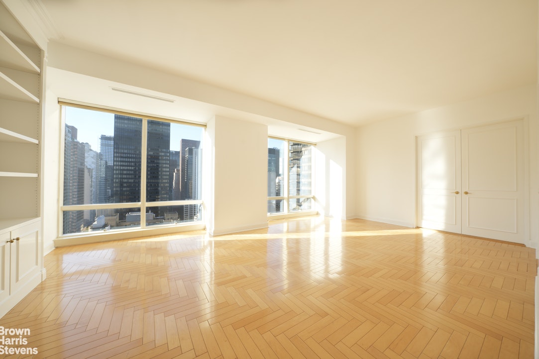 845 United Nations Plaza, Unit 33D Manhattan, NY 10017 - Photo 8 of 11 a view of an empty room with glass door