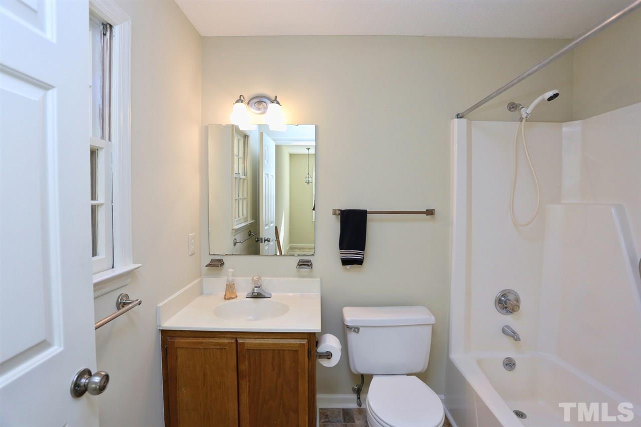1124 Toppe Ridge Court Raleigh, NC 27615 - Photo 23 of 25 a bathroom with a toilet sink and mirror