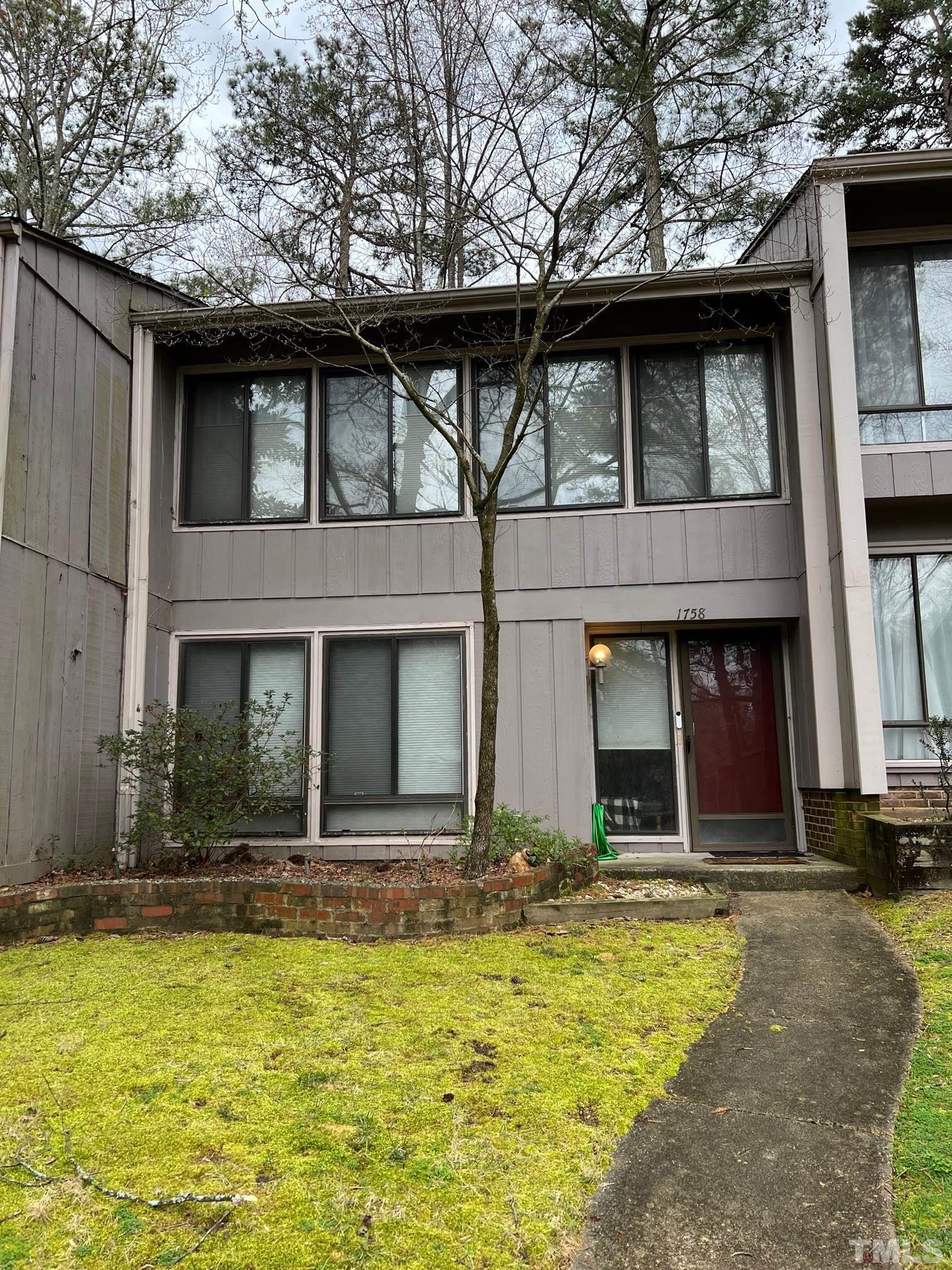 1758 Quail Ridge Road Raleigh, NC 27609 - Photo 5 of 37 a view of a building with a yard