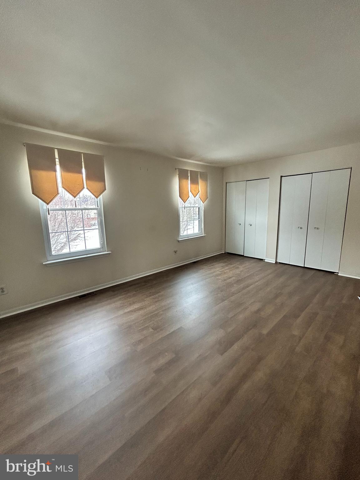 25 Ruth Road Brookhaven, PA 19015 - Photo 11 of 18 an empty room with wooden floor and windows
