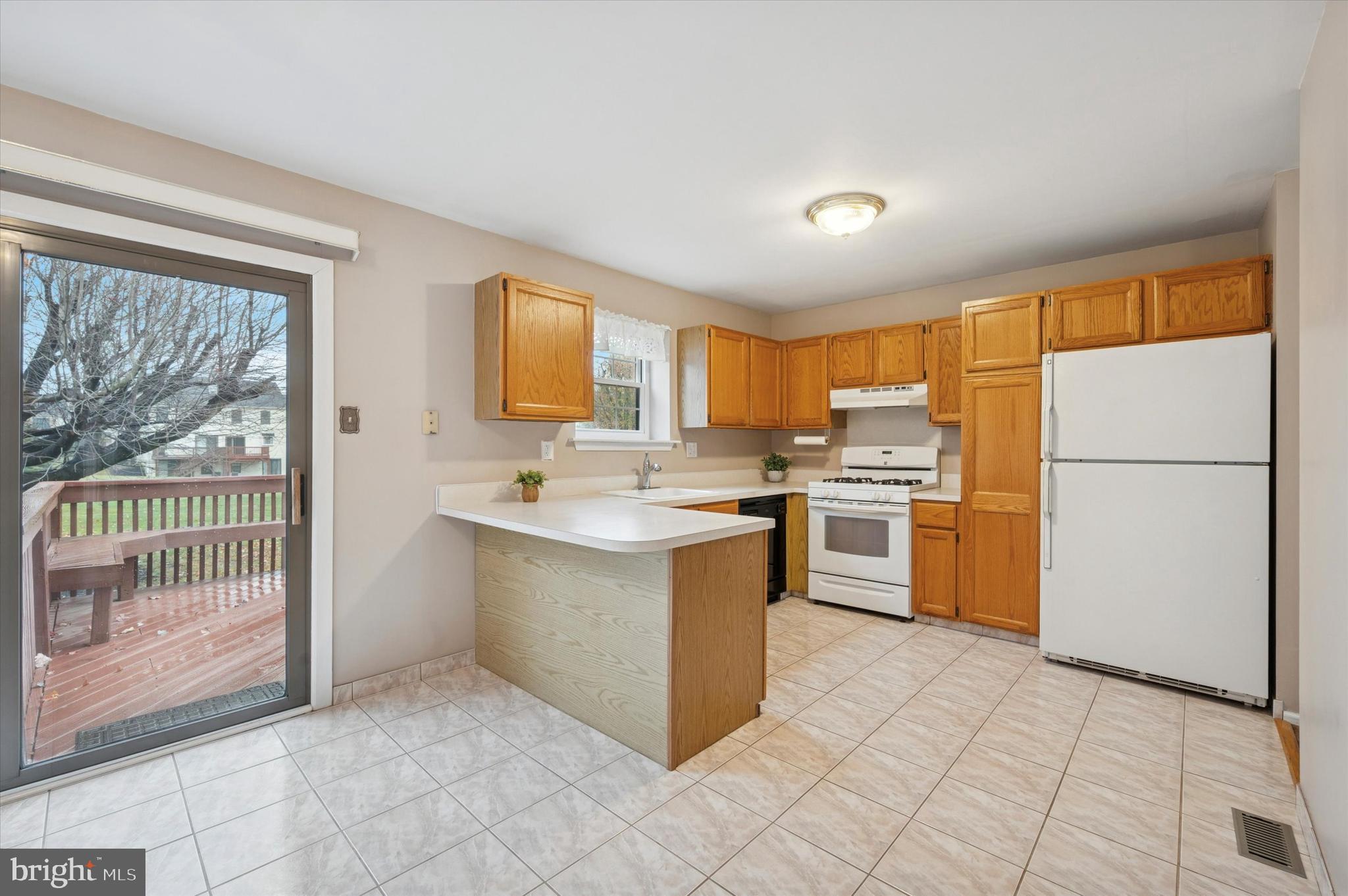25 Ruth Road Brookhaven, PA 19015 - Photo 8 of 18 a kitchen with white cabinets and white appliances