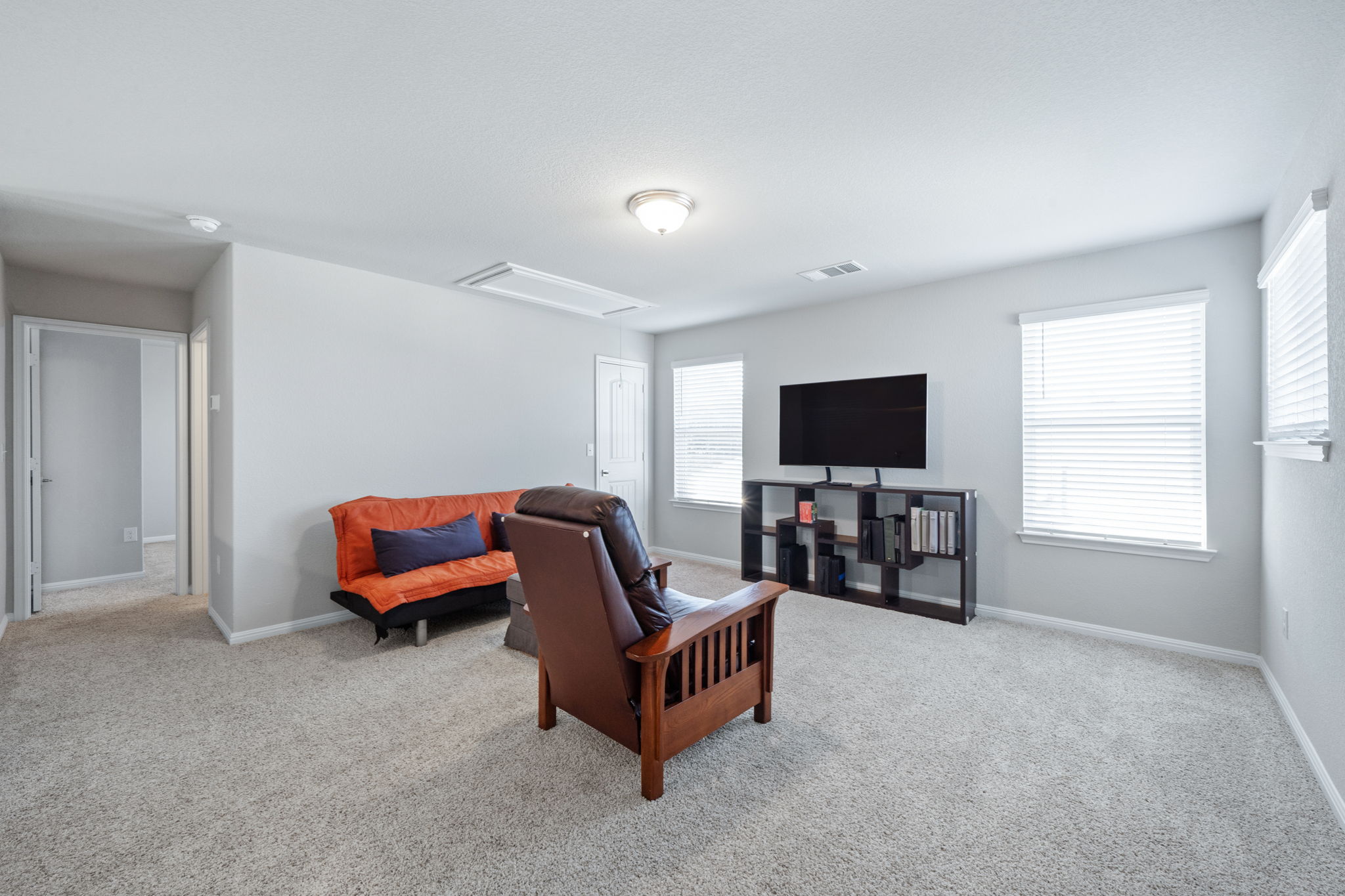 2412 Starhill Ranch Street Georgetown, TX 78628 - Photo 31 of 40 A versatile living area with soft carpeting and ample natural light offers comfortable relaxation.