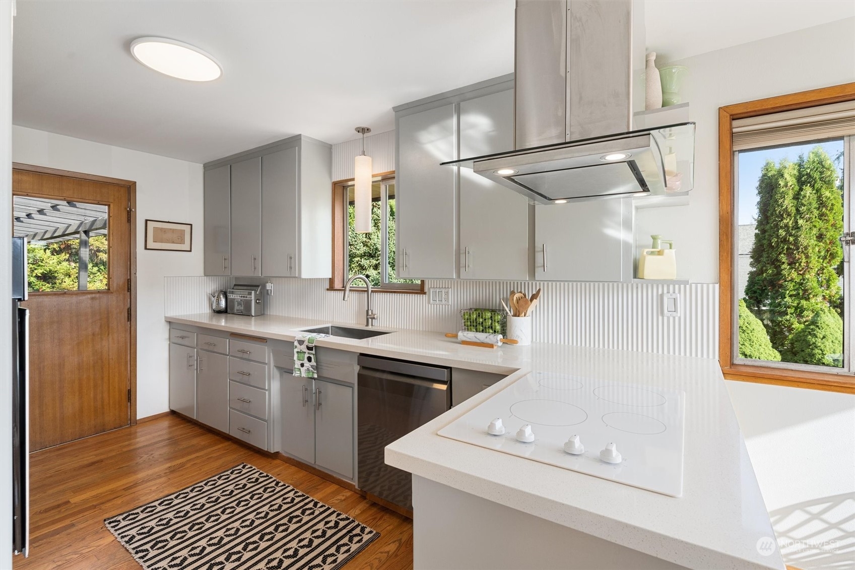 3616 Southwest 112th Street Seattle, WA 98146 - Photo 12 of 40 a kitchen with a sink cabinets stainless steel appliances and a window