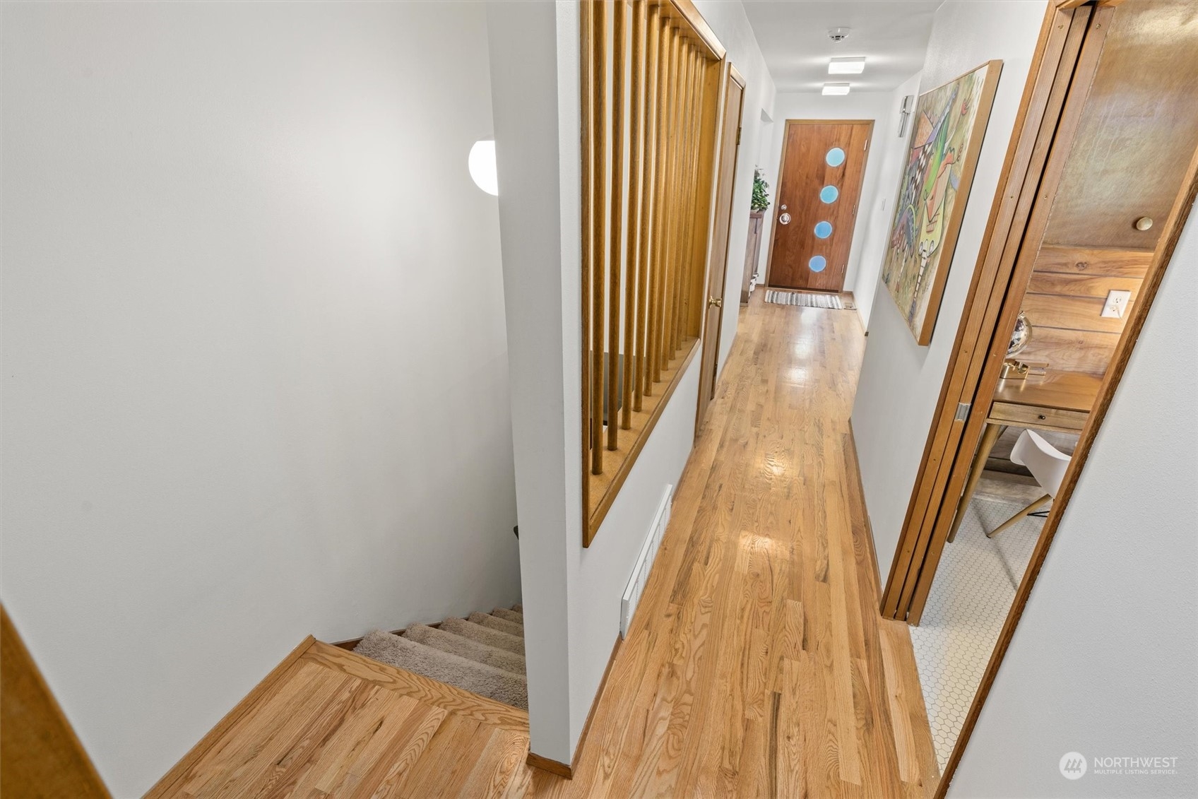 3616 Southwest 112th Street Seattle, WA 98146 - Photo 25 of 40 a view of a hallway with wooden floor and staircase