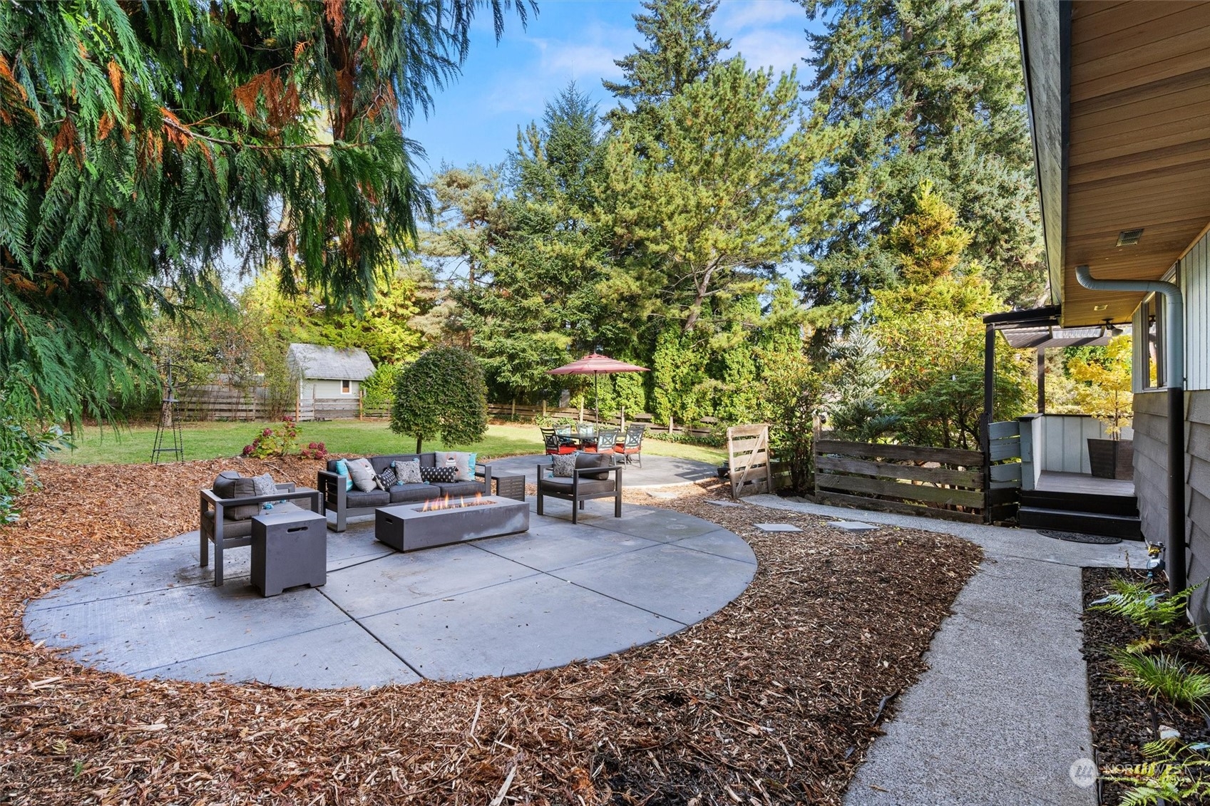 3616 Southwest 112th Street Seattle, WA 98146 - Photo 34 of 40 a view of a patio with table and chairs potted plants and a large tree
