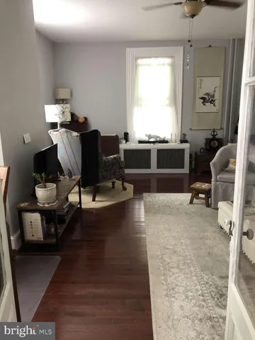 a living room with furniture gym equipment and a window