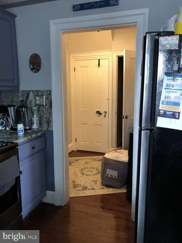 a view of walk in closet with wooden floor