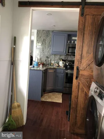 a kitchen with stainless steel appliances granite countertop a refrigerator a stove and a sink