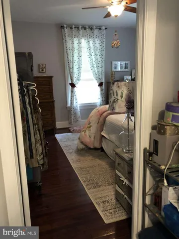 a bedroom with a bed next to a window