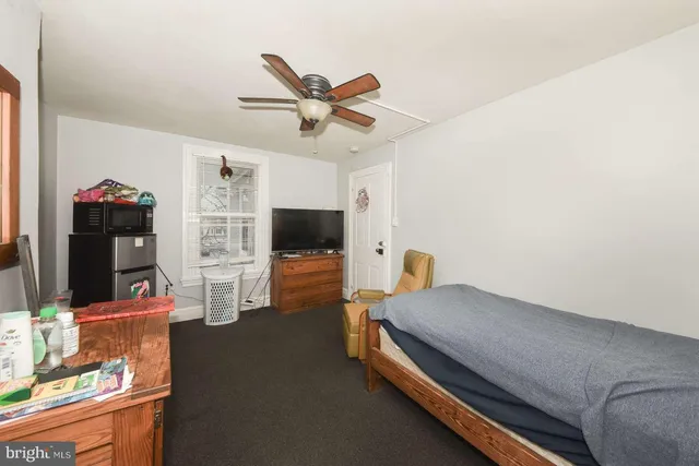 a bedroom with furniture and a flat screen tv