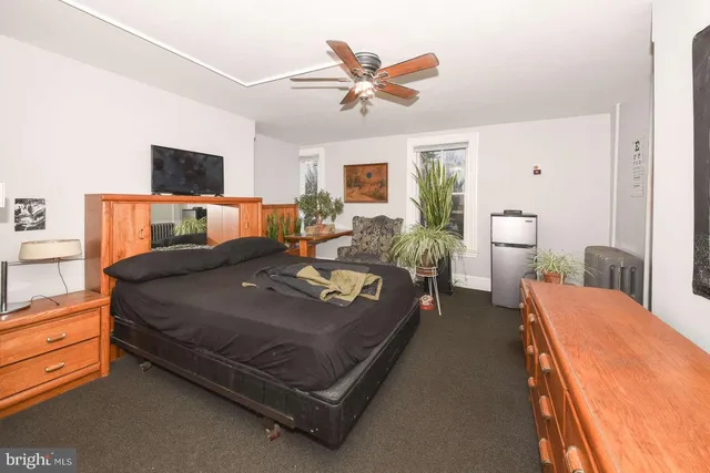 a bed room with a bed and a television