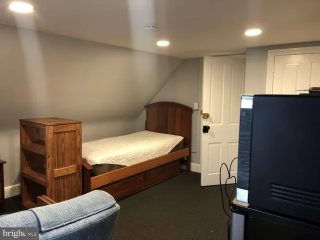 a bedroom with a bed and a couch