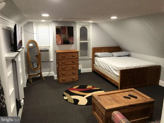 a bedroom with bed and gym equipment