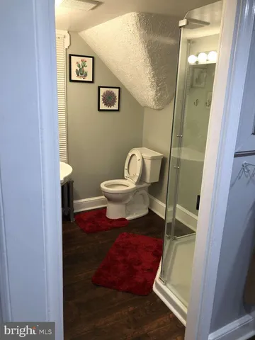 a bathroom with a toilet and a mirror